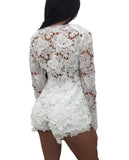 A person wearing a white 2 Piece V-Neck Slim Long Sleeve Hollow Out Lace Cardigan. The lace features an intricate floral design, and the garment is semi-transparent, with delicate flower patterns covering the body. The person is standing with their back to the camera, highlighting the detailed texture of the cardigan.